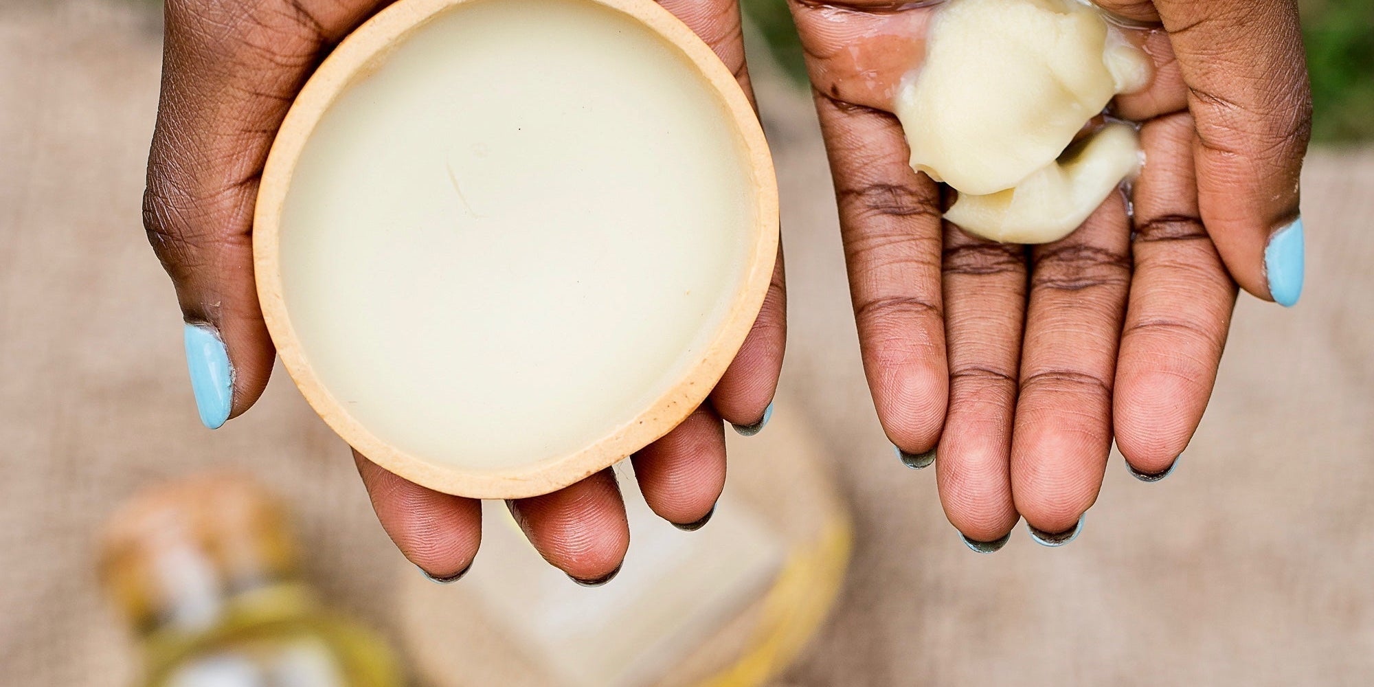 picture of shea butter in a calabash and hand