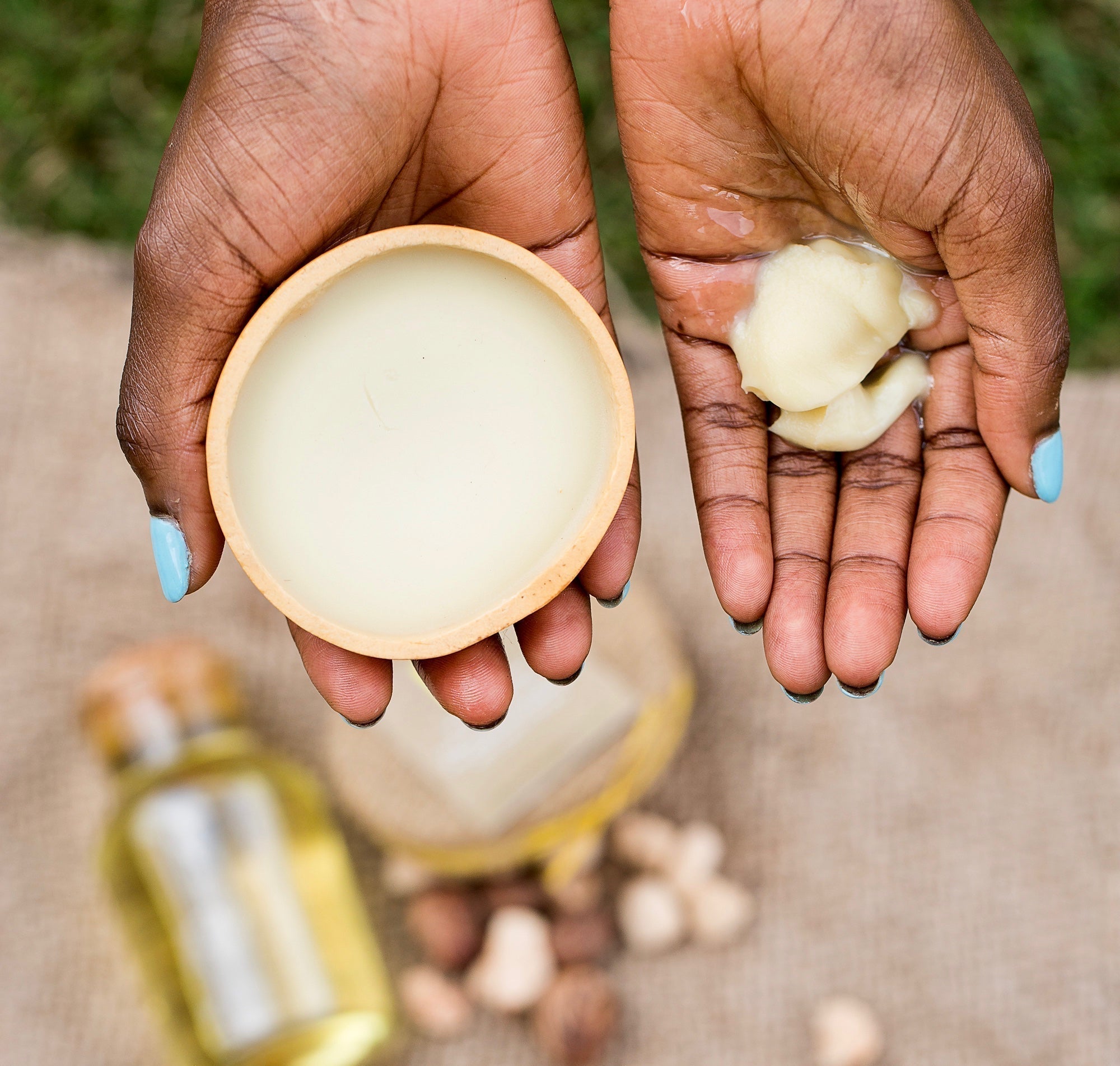 picture of shea butter in a calabash and hand