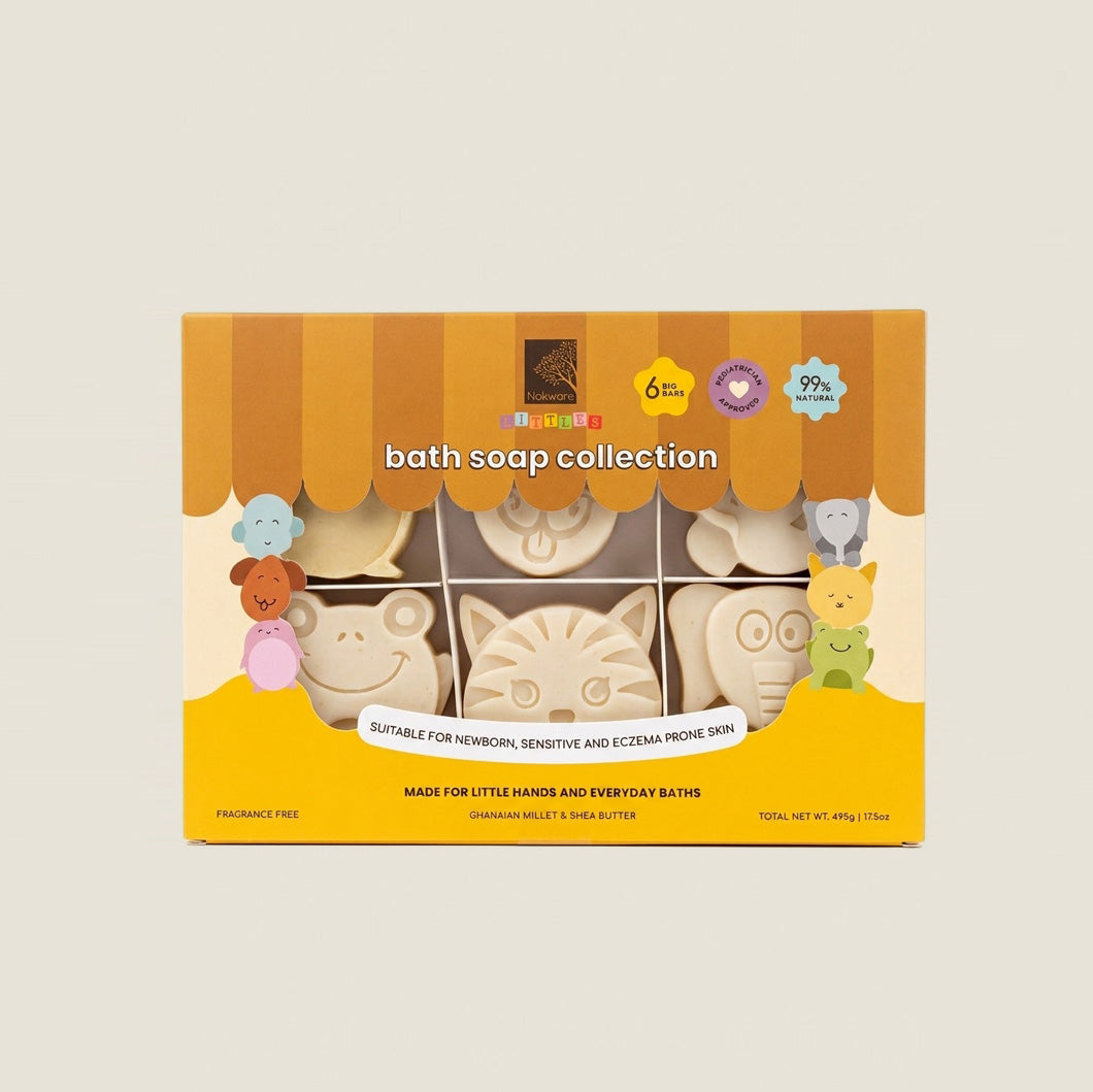 A boxed bath soap collection displayed against a light beige background. The packaging is yellow and brown with cartoon animal illustrations and a window showing several pale cream-colored bath soaps shaped like animals .