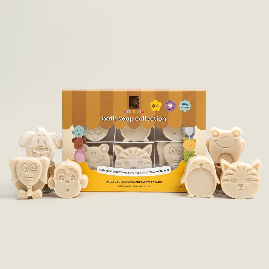 A bath soap collection set displayed in front of its yellow and brown striped retail box on a light beige background. The set includes multiple small, animal soaps in a beige color