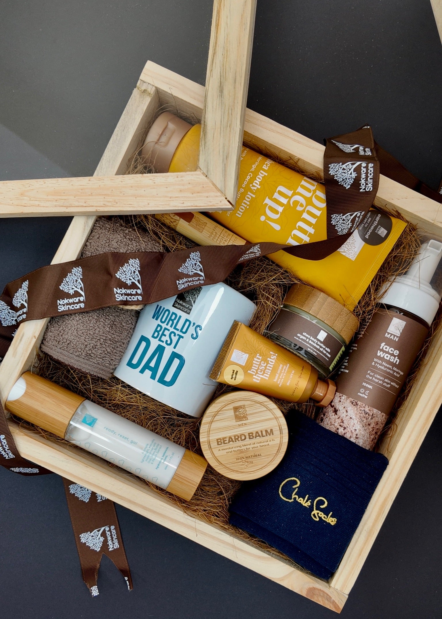Nokware Skincare gift set for fathers day with 'World's Best Dad' mug, beard products, and other items in a wooden box.